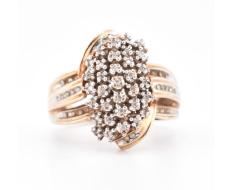 A hallmarked 9ct gold and diamond cluster ring. The 9ct gold ring set with 61 round brilliant cut diamonds set in a decorativ