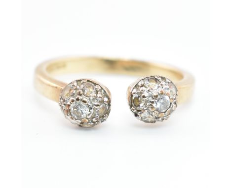 A hallmarked 9ct gold and CZ ball torque ring. The 9ct yellow gold torque ring having two ball finials set each with six pave