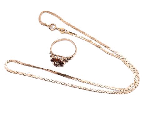 A hallmarked 9ct gold and garnet cluster ring and a 9ct gold serpentine chain necklace. The lot to include a hallmarked 9ct y