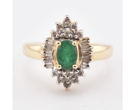 A 14ct gold emerald and diamond halo cluster ring. The 14ct yellow gold ring set with a central oval cut emerald surrounded b