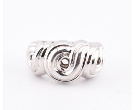 An 18ct white gold Boucheron ring. The 18ct white gold Boucheron ring having a swirled design to tapered shank. Marked Bouche