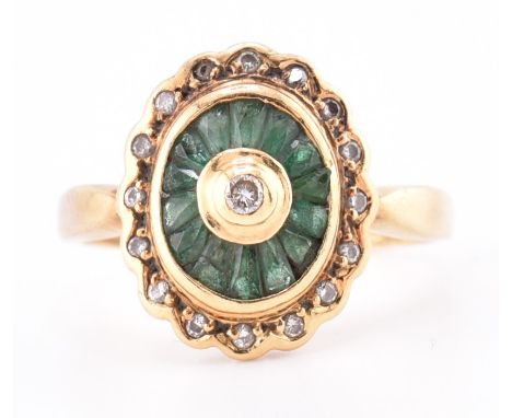 A hallmarked 18ct gold, emerald and diamond ring. The 18ct yellow gold ring having a central bezel set round brilliant cut di