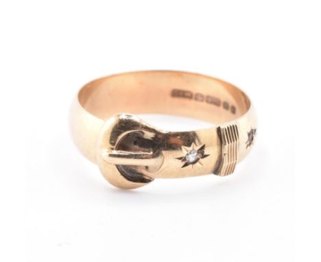 A hallmarked 9ct gold, ruby and diamond buckle ring. The 9ct yellow gold belt buckle motif ring set with a star set round bri