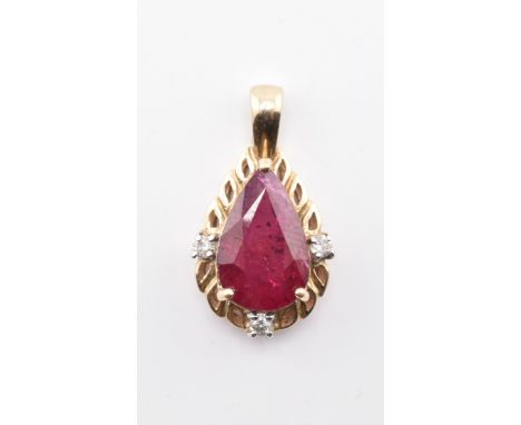 A hallmarked 9ct gold ruby and diamond necklace pendant. The 9ct yellow gold necklace pendant set with a central pear cut rub