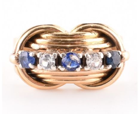 18ct gold and sapphire five stone ring. The round brilliant cut sapphires with white stones. Stamped 18ct. Total weight 8.96g