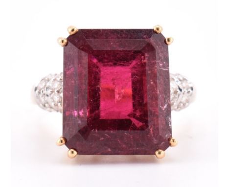 A hallmarked 18ct gold pink tourmaline and diamond ring. The 18ct yellow gold ring set with a central double claw set emerald