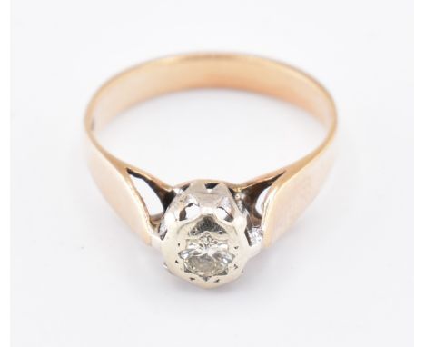 Gold and diamond solitaire ring. The ring set with a single star set round brilliant cut diamond to polished shank. Date lett