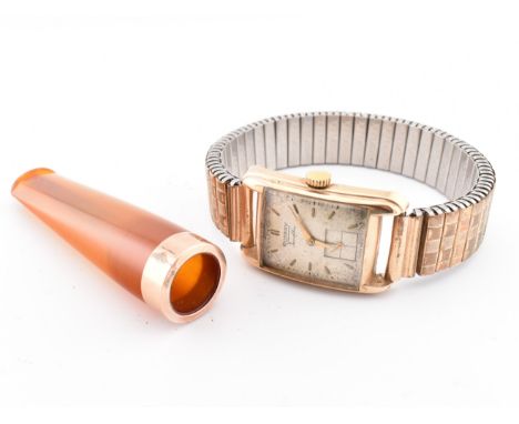 A hallmarked 9ct gold Rotary wristwatch together with a cased gold mounted cheroot holder. The lot to include a hallmarked 9c
