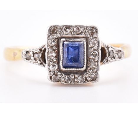 An 18ct gold and platinum diamond and sapphire Art Deco ring. The 18ct yellow gold Art Deco ring having a central millegrain 