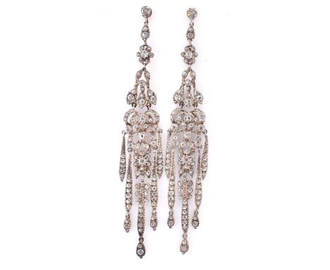 A pair of antique paste pendant earrings. The silver chandelier pendant earrings set with round cut paste to straight posts. 