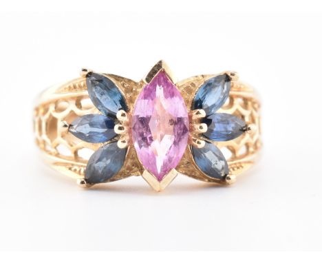 A hallmarked 9ct gold, pink sapphire and blue sapphire ring. The 9ct yellow gold ring set with a central marquise cut pink sa