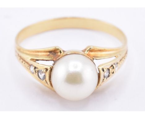Contiental high carat pearl and white stone ring. The central pearl with white stone accented shoulders to a tapering band. A