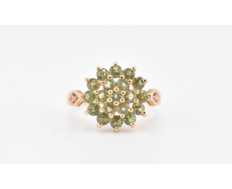 A hallmarked 9ct gold green sapphire and pink tourmaline cluster ring. The 9ct yellow gold ring set with a cluster of 19 roun