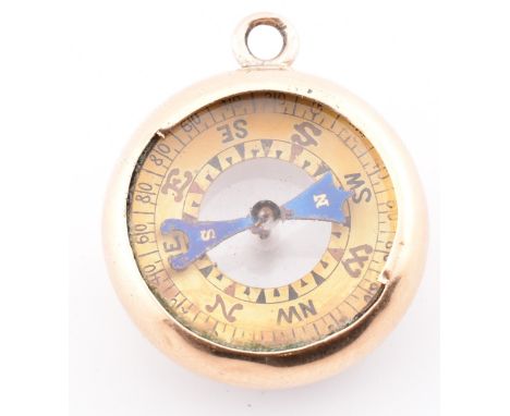 A gold dual compass and barometer pendant. The gold pendant having a compass on one side with a barometer on the verso to gol