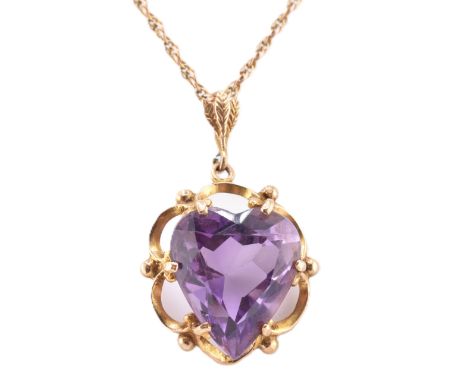 A gold and amethyst heart pendant necklace. The pendant necklace having a heart cut amethyst set in a decorative setting to f