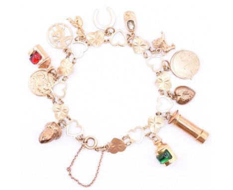 A hallmarked 9ct gold heart link chain charm bracelet. The 9ct gold heart link chain bracelet strung with twelve charms to sp