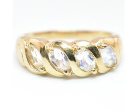 A hallmarked 9ct gold Sri Lankan rainbow moonstone four stone ring. The 9ct yellow gold ring set with four oval cut Sri Lanka
