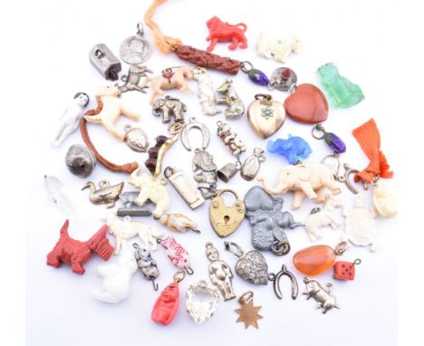 Assorted charms. The mixed lot of charms to include a yellow metal peas in a pod charm, various elephants, Joan of Arc medall
