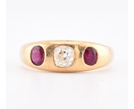 An 18ct gold ruby and diamond gypsy ring. The 18ct yellow gold gypsy ring set with a central rubover set mixed cut diamond fl