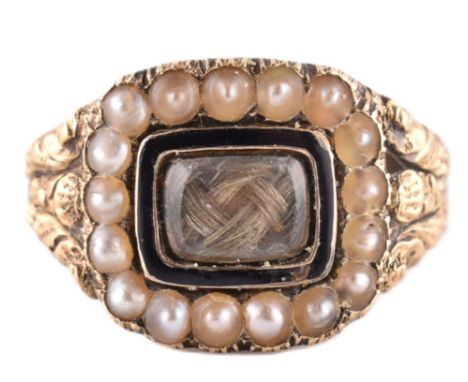 Georgian gold seed pearl and hair locket mourning ring. The ring having a pearl and enamel framed hair locket with decorative