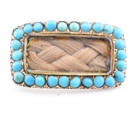 A gold and turquoise mourning brooch pin. The antique yellow gold mourning brooch pin having a central rectangular glazed pan