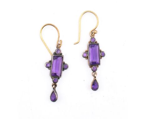 A pair of early 20th century amethyst pendant earrings. The earrings mounted with a central step-cut amethyst with round mixe