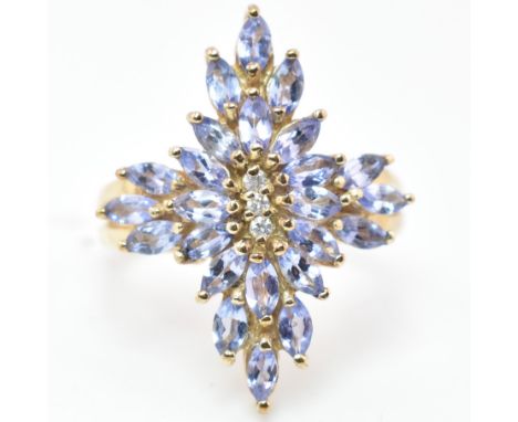 A hallmarked 9ct gold tanzanite and diamond snowflake cluster ring. The 9ct yellow gold ring set with three round cut diamond