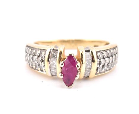 A 14ct gold ruby and diamond ring. The ring set with a central marquise cut ruby flanked by two columns of bar set calibre cu