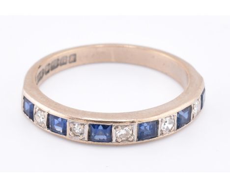 A hallmarked 18ct gold sapphire and diamond half hoop ring. The 18ct white gold ring set with six channel set calibre cut sap