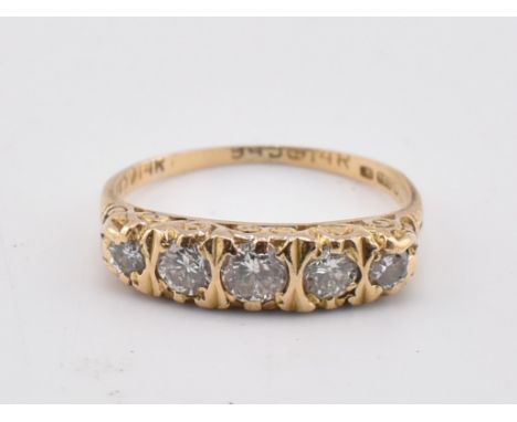 A hallmarked 18ct gold and diamond five stone ring. The 18ct yellow gold ring set with five graduating round brilliant cut di