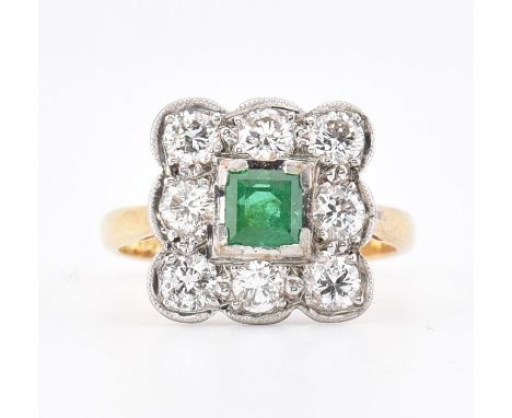 An 18ct gold and platinum, emerald and diamond cluster ring. The 18ct yellow gold ring having a central half bezel set step c