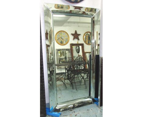 PHILIPPE STARCK WALL MIRROR, with curved polished metal frame, 106cm x 196cm H.with small circular hole in plate for the inse