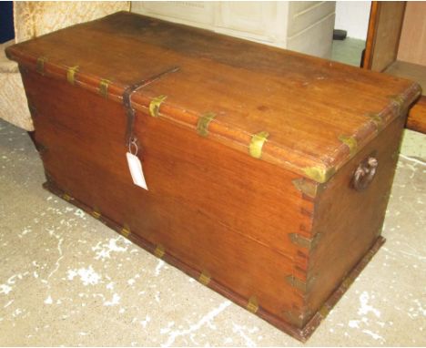 INDIAN HARDWOOD TRUNK, with brass binding and iron side handles, 132cm L x 57cm D x 63cm H. 