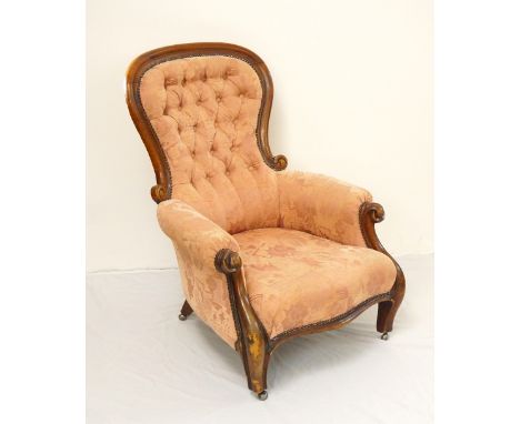 VICTORIAN MAHOGANY BUTTON BACK ARMCHAIR
with scroll arms above a shaped seat, standing on shaped front supports with castors 