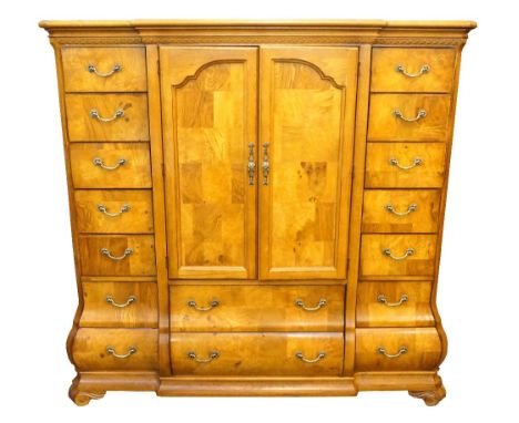 POLASKIA AMERICAN LIGHT BURR OAK BREAKFRONT DRESSING CHEST
with a pair of central cupboard doors above two long drawers, flan