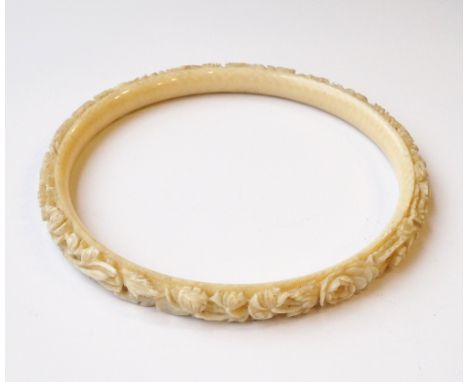 VINTAGE CARVED IVORY BANGLE
with floral decoration, 10cm diameter