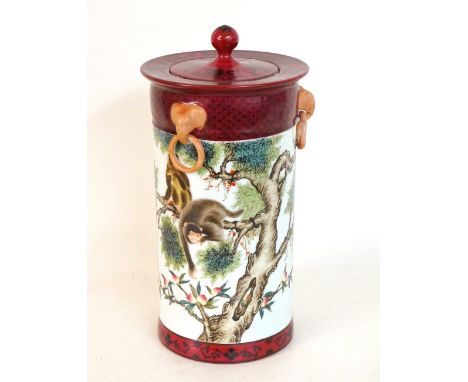 CHINESE LIDDED PORCELAIN VASE 
of cylindrical form with a flared plum coloured rim, the lid with a knopped finial above three