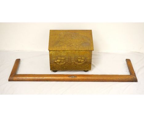 EMBOSSED BRASS COAL BIN
with a slanted lift up lid decorated with a castle, the front panel with ships and a light house, the