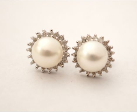 PAIR OF PEARL AND DIAMOND CLUSTER STUD EARRINGS
the central pearl on each in diamond surround, in nine carat white gold, the 