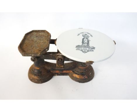 SET OF VICTORIAN CAST IRON SCALES
with a circular pottery stand to the weighing arm  