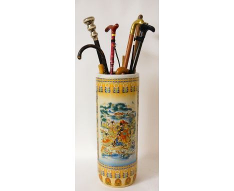 CHINESE POTTERY STICK STAND
elaborately decorated with flowers and two panels of women playing musical instruments, 60.5cm hi