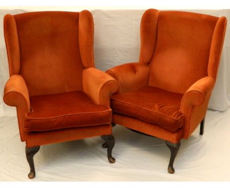 PAIR OF VICTORIAN STYLE WING BACK ARMCHAIRS
with scroll arms and a loose cushion seat, covered in a terracotta plush, standin