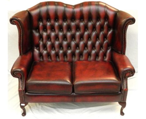 LEATHER CHESTERFIELD BUTTON BACK SOFA
in ox blood red leather with stud detail, standing on cabriole supports  