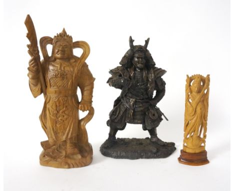 VIETNAMESE CARVED FIGURE OF A WARRIOR
clutching a guan dao, on a naturalistic base, 29cm high; an East Asian deity playing a 