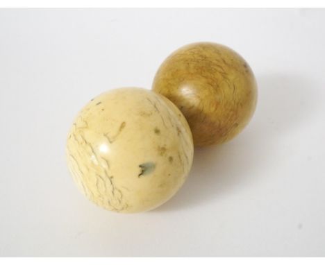 TWO VINTAGE IVORY BILLIARD BALLS
6cm and 5.8cm diameter, approximately 370 grams total weight 