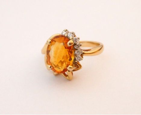 CITRINE AND DIAMOND CLUSTER DRESS RING
in unusual pierced setting, the citrine approximately 4cts and the diamonds totalling 