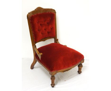 VICTORIAN OAK NURSING CHAIR
with red fabric button-back and seat, raised on shaped and turned front legs