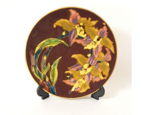 ZSOLNAY PECS PLATE
with floral decoration on a burgundy ground, impressed mark to reverse and numbered 978, 21.5cm diameter