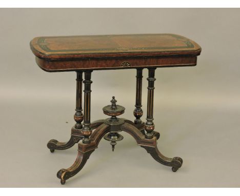 A Victorian amboyna and ebonised card table, with four columns