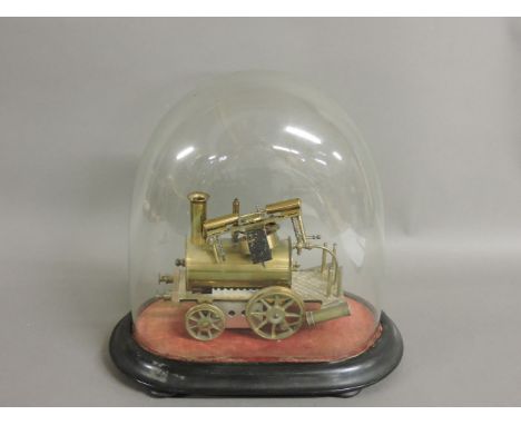 A brass scale model of an early steam engine, paraffin fuelled, under a glass dome